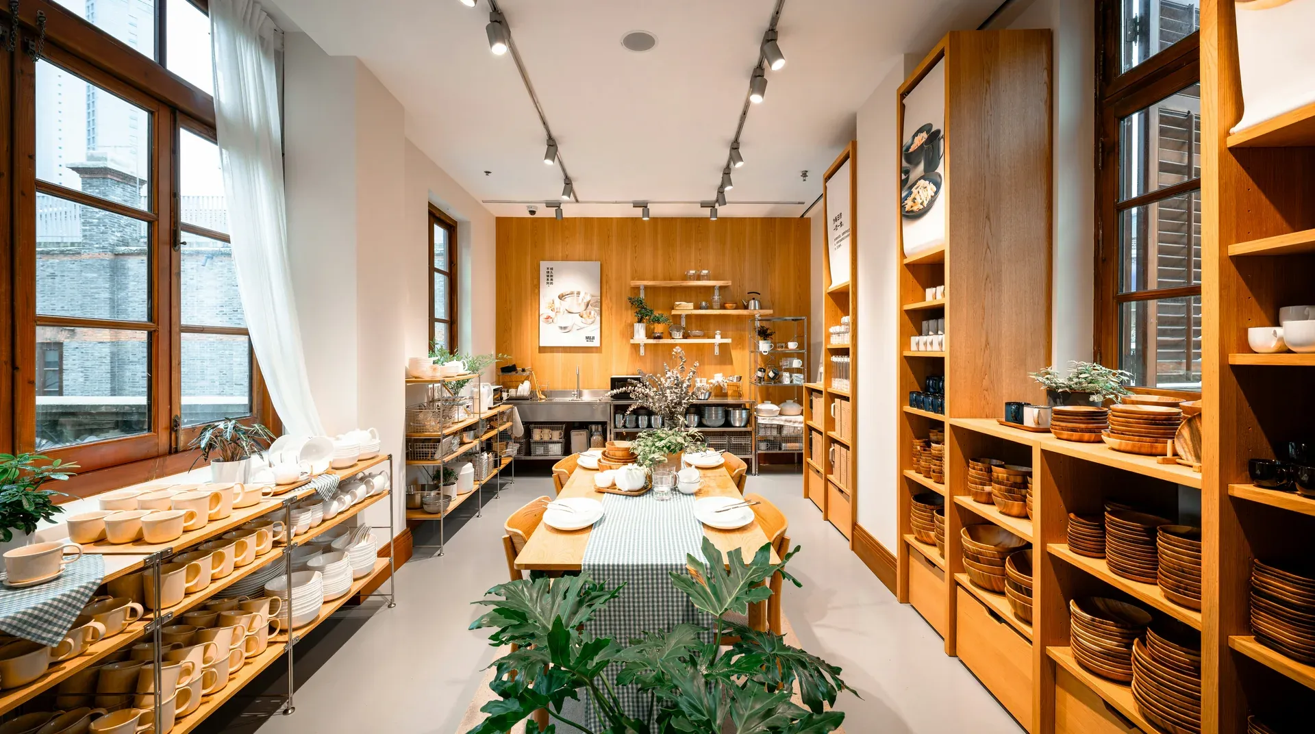 Warm, sunlit shop interior with wooden shelves and a display table