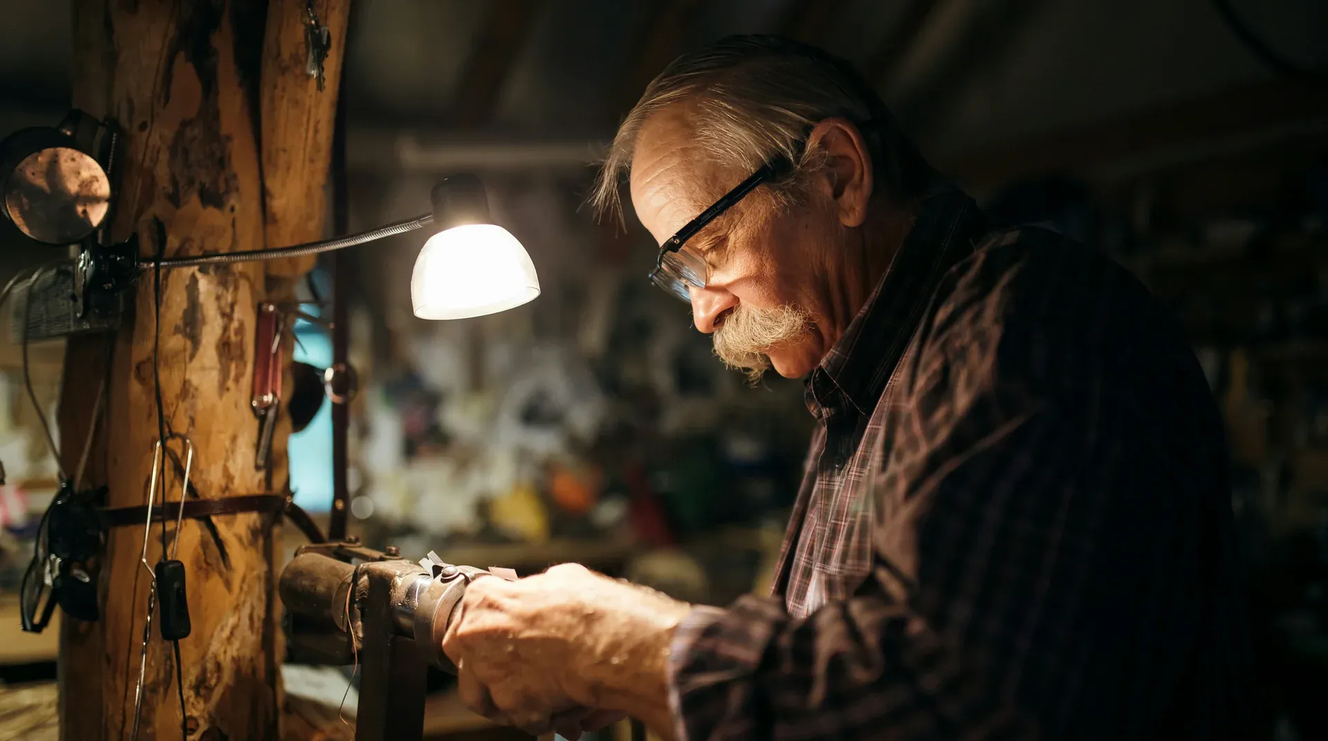 A seasoned craftsman at work in his warmly lit workshop