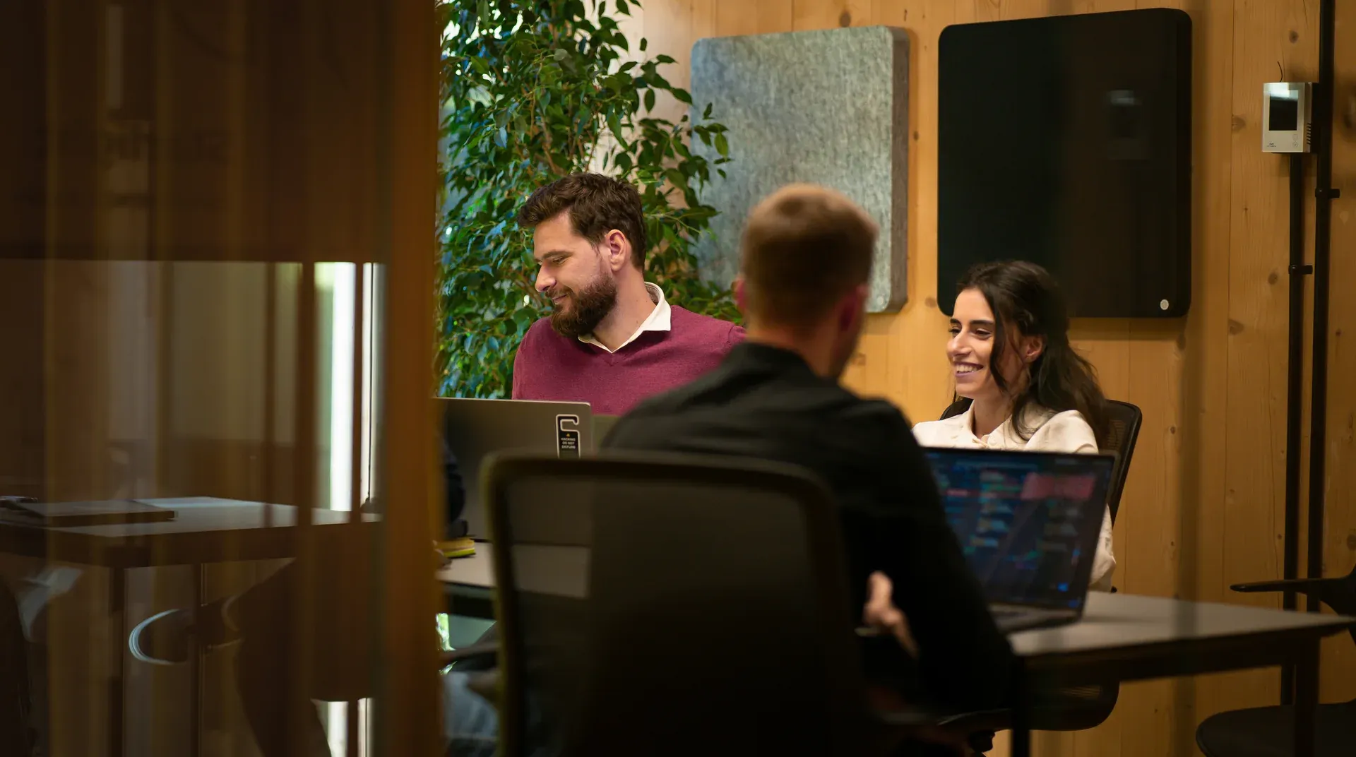 Business partners meeting around a table in a warm, modern office